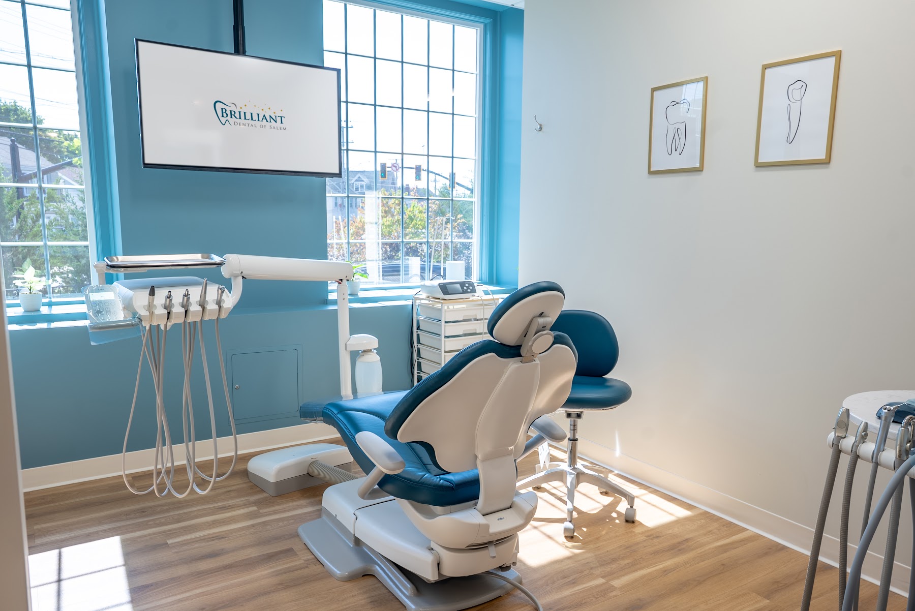 Treatment room at Brilliant Dental of Salem with a modern dental chair and chairside monitor